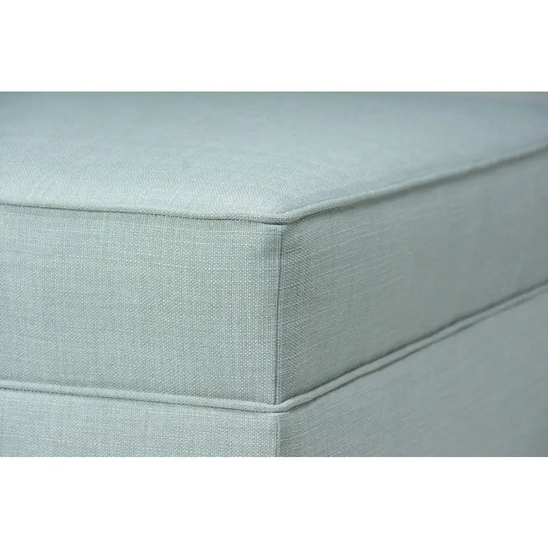 Grand pouf ottoman rembourré avec passepoil