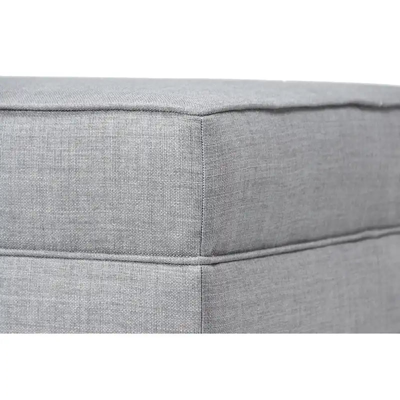 Grand pouf ottoman rembourré avec passepoil